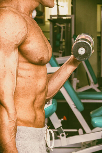 Strong with muscular body at the gym