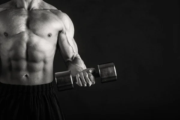 Bodybuilder  on a dark background. — Stock Photo, Image