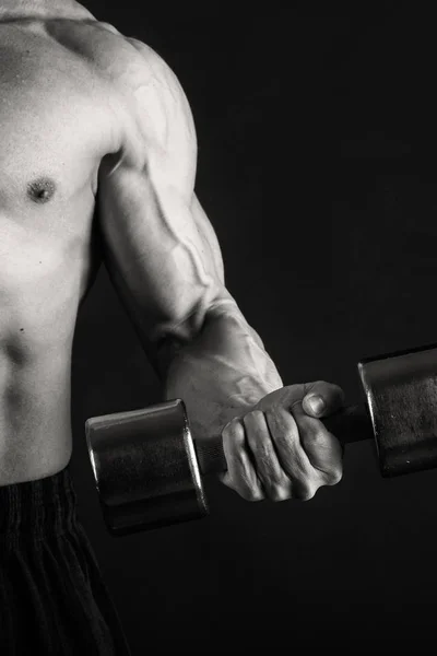 Bodybuilder  on a dark background. — Stock Photo, Image