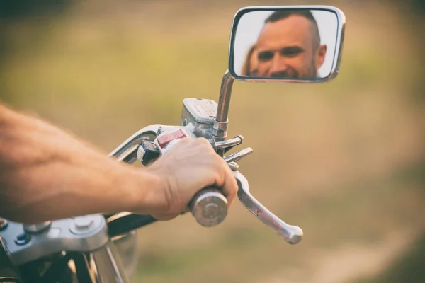 Young couple on a motorcycle in the field — Stock Photo, Image