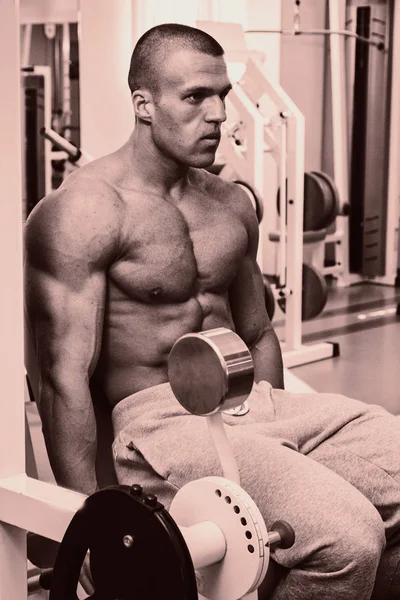 A man with a barbell exercise on biceps — Stock Photo, Image