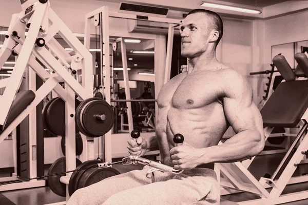 A man with a barbell exercise on biceps — Stock Photo, Image
