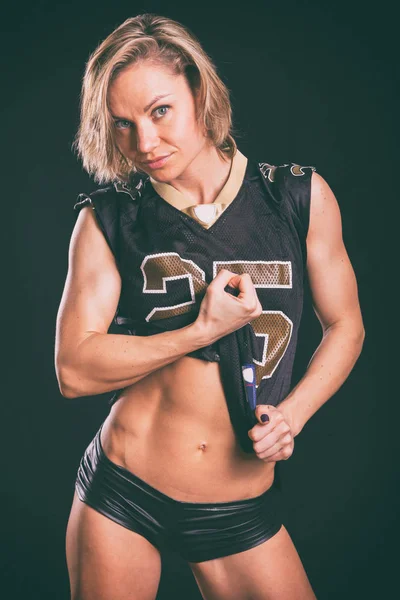 Muscular blonde on a dark background. — Stock Photo, Image