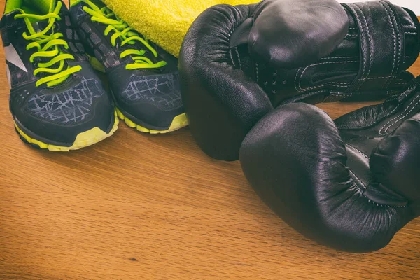 Boxing gloves, a towel and water. All fitness