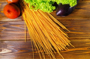 Spagetti ve sebze ahşap arka plan üzerinde