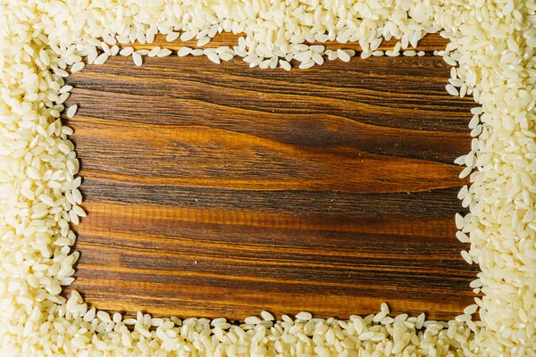 Rice on a wooden table — Stock Photo, Image