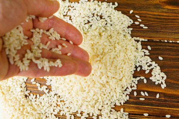 Rice on a wooden table — Stock Photo, Image