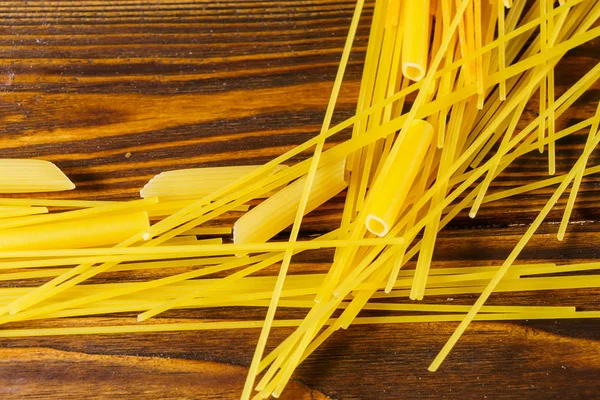 Macaroni on a wooden table — Stock Photo, Image