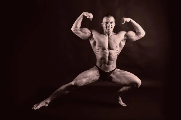 Bodybuilder on black — Stock Photo, Image