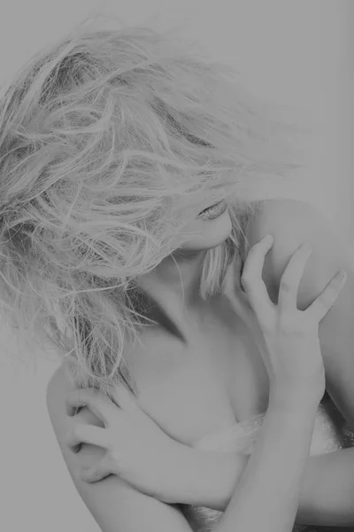 Gorgeous disheveled blonde on a dark background. — Stock Photo, Image
