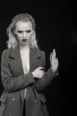 Siyah arka planda güzel, seksi sarışın kadın.