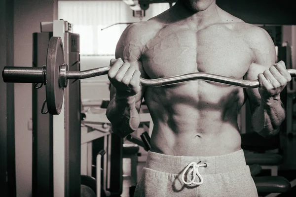 Muscular man working out in gym doing exercises — Stock Photo, Image