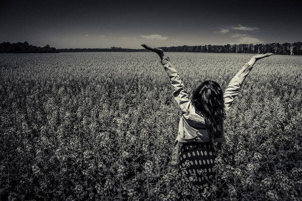 A girl in a rapeseed field