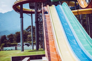 The boy rides a slide in the water park