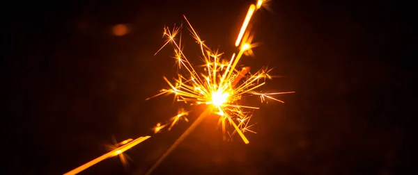 Sparklers for Christmas and New Year close-up in the form of a banner and on a black background — Stock Photo, Image