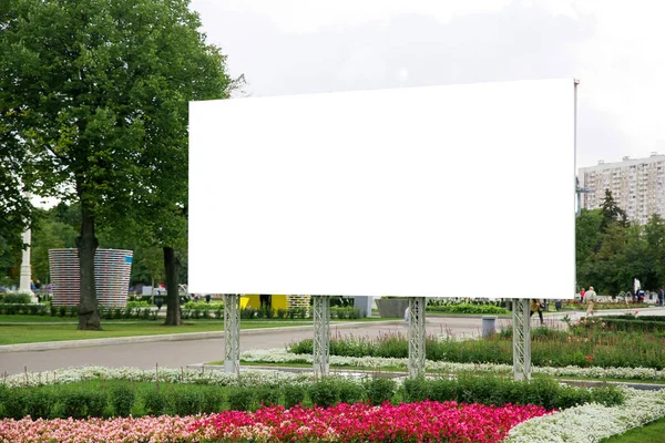 large white blank banner for advertising closeup in the city Park on the background of nature and flowers