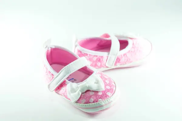 Růžové a bílé dětské boty na bílém pozadí. — Stock fotografie