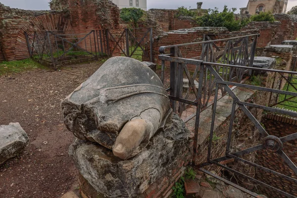 Ruins on the Palatine hill in Rome. A fragment of a marble statue. Toe
