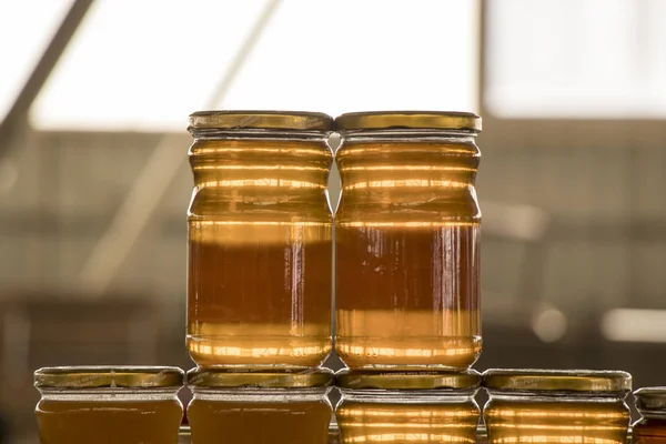 Stacked Honey Bottles For Sale At Market. Stock photo.