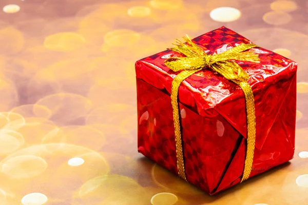 Christmas concept. One wrapped gift box with ribbon.