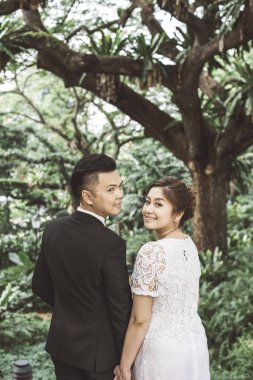 Asyalı sevgili çift düğün öncesi açık hava fotoğraf çekimi. Sıradan doğal insan portreleri..