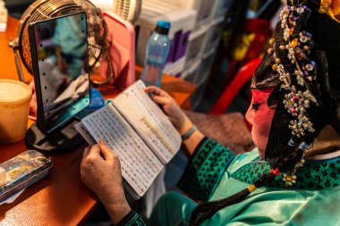 Çinli opera sanatçısı senaryoları okuyor.