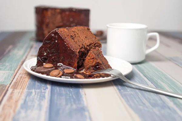 Sacher Cake.Typical Austrian chocolate cake, with a thin layer of apricot jam, and a cup of coffee.