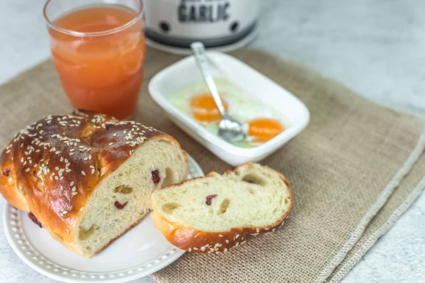 Healthy breakfast and brunch on table. Home-baked raisin bread, cup of grapefruit juice, and soft-boiled eggs. — Stock Photo, Image