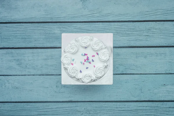 White frost cake frosting, isolated on kitchen table. Flat lay top down view.