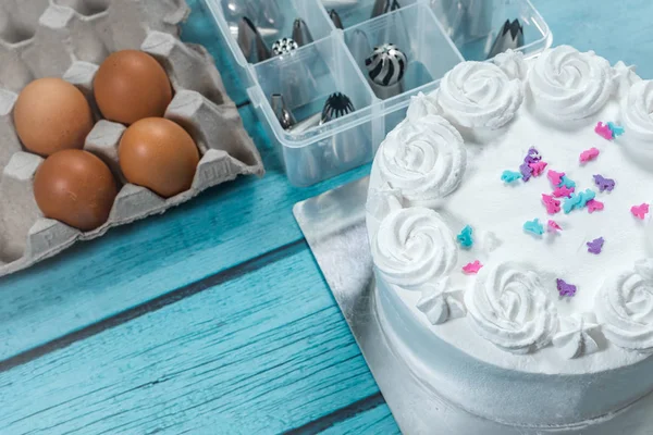 Cake baking making and frosting utensils accessories and raw eggs kitchen on table — ストック写真