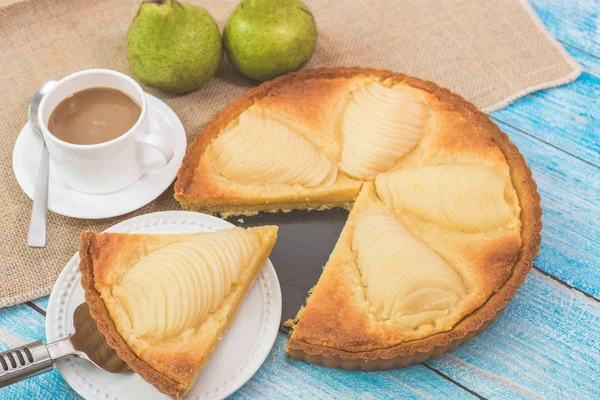 Lezzetli ev yapımı haşlanmış armutlu turta, Tarte Bourdaloue olarak bilinir, bir fincan kahve latte. Fransız popüler tarifi Paris 'teki bir sokaktan geliyor. Yemek masa konsepti.
