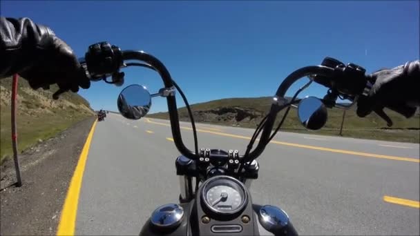 First person pov shot of professional biker riding fast downhill on fascinating highway road on black sport motor bike — Stock video