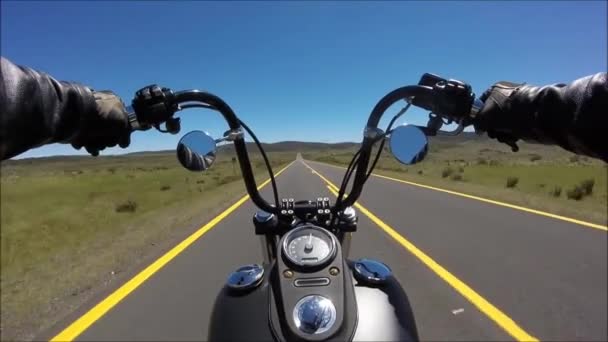 First person pov shot of professional biker riding fast downhill highway road on black motor bike in stunning landscape — Stock Video