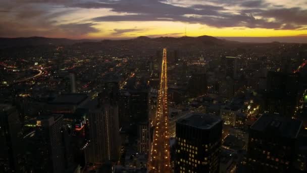 サンフランシスコの穏やかな海の川を渡る壮大な空中ドローン飛行夜のライトダウンタウンスカイライン日没の街並み — ストック動画