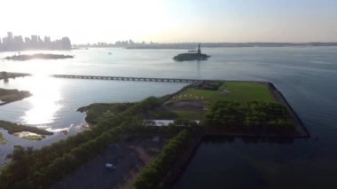 Amerika Birleşik Devletleri 'nin Amerikan Özgürlük Heykeli' nin, ıssız ada okyanus günbatımında çekilmiş fevkalade hava aracı görüntüleri.