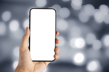 Gri bokeh arkaplanda akıllı telefon boş ekranı