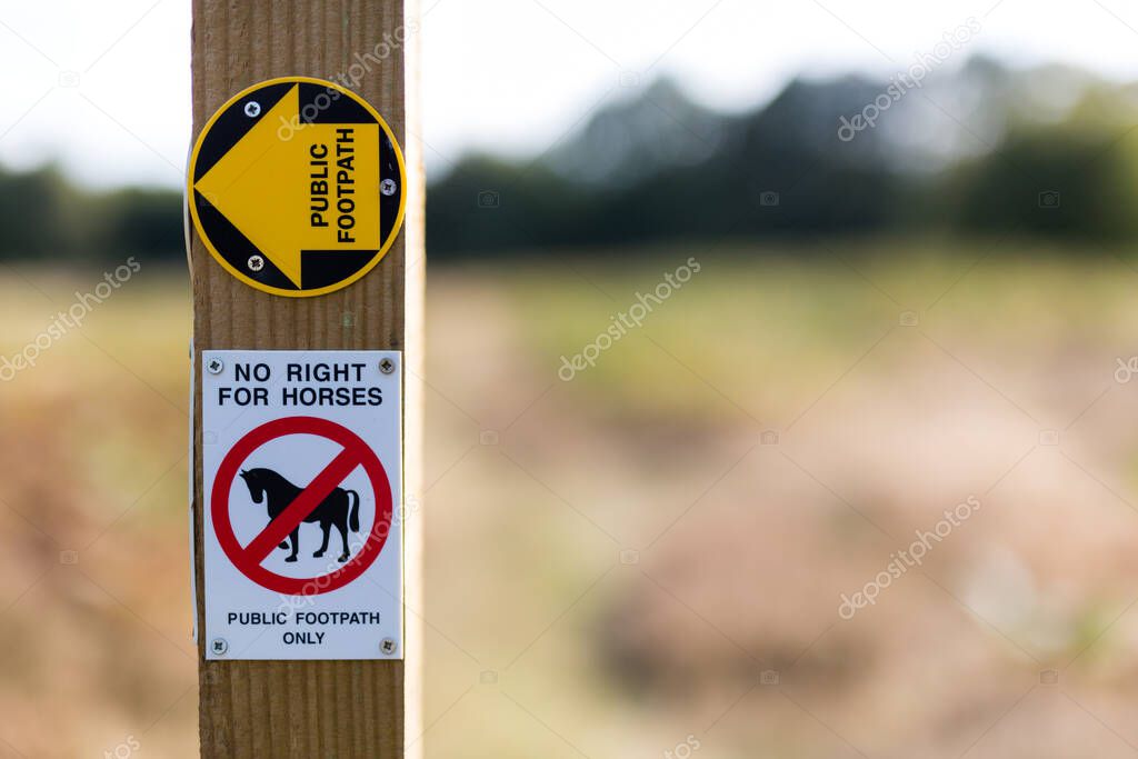 Rural signpost showing that is a public footpath only, no horses allowed