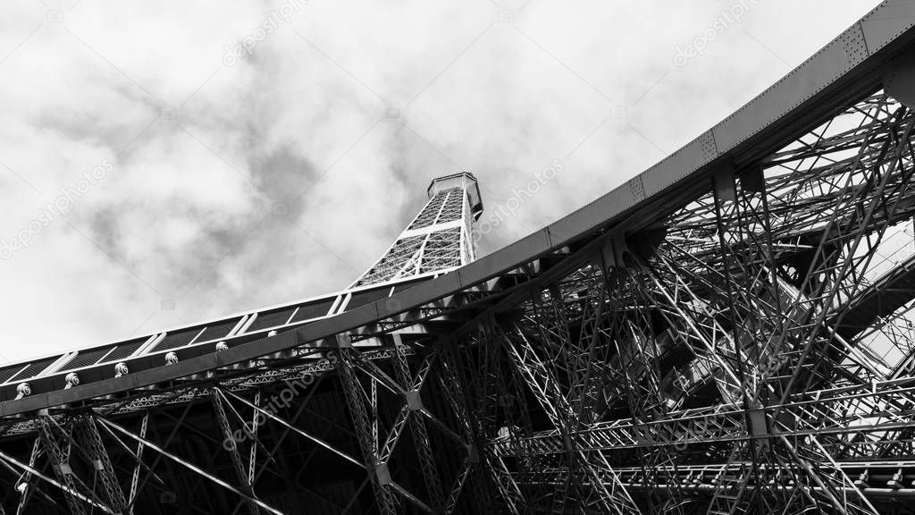 Looking up on Eiffel Tower, the most popular landmark of Paris, France. Monochrome photo