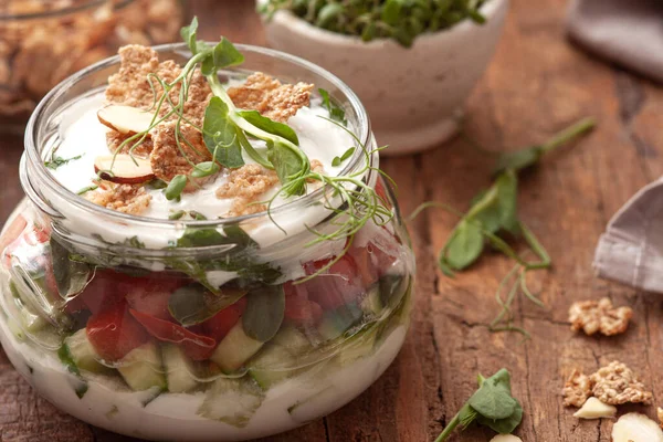 Fresh vegetable salad in jars with yogurt dressing