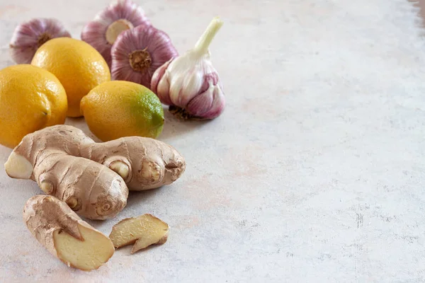 Ginger root , fresh lemons and garlic on a white background.Alternative medicine.Virus protection food, coronavirus, immunity concept