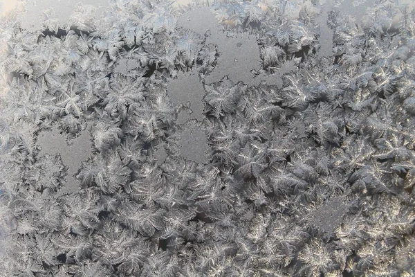 Beautiful frosty pattern on the winter window — Stock Photo, Image