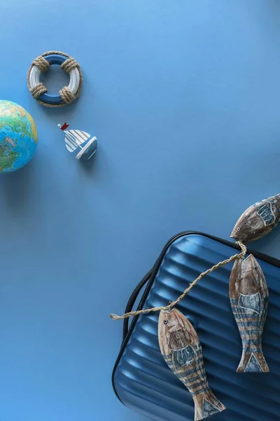 Travel, tourism and vacation concept background. Blue suitcase with traveler symbols on a blue background. — 스톡 사진