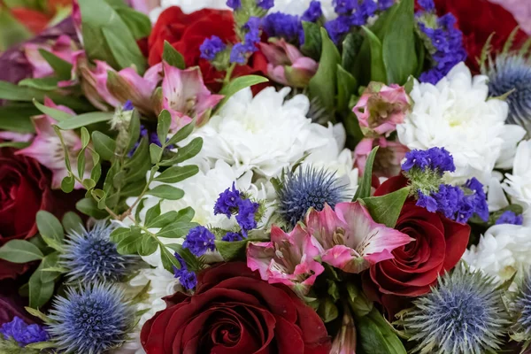 En bukett med krysantemum, rosor och echinops. Bakgrund. — Stockfoto