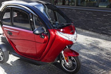 Şehir merkezinin ortasına park edilmiş kırmızı bir bisiklet.