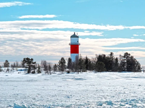 lighthouse in winter landscape with sunshine