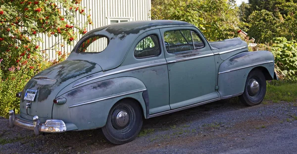 An old worn out car standing in a ridge — 스톡 사진