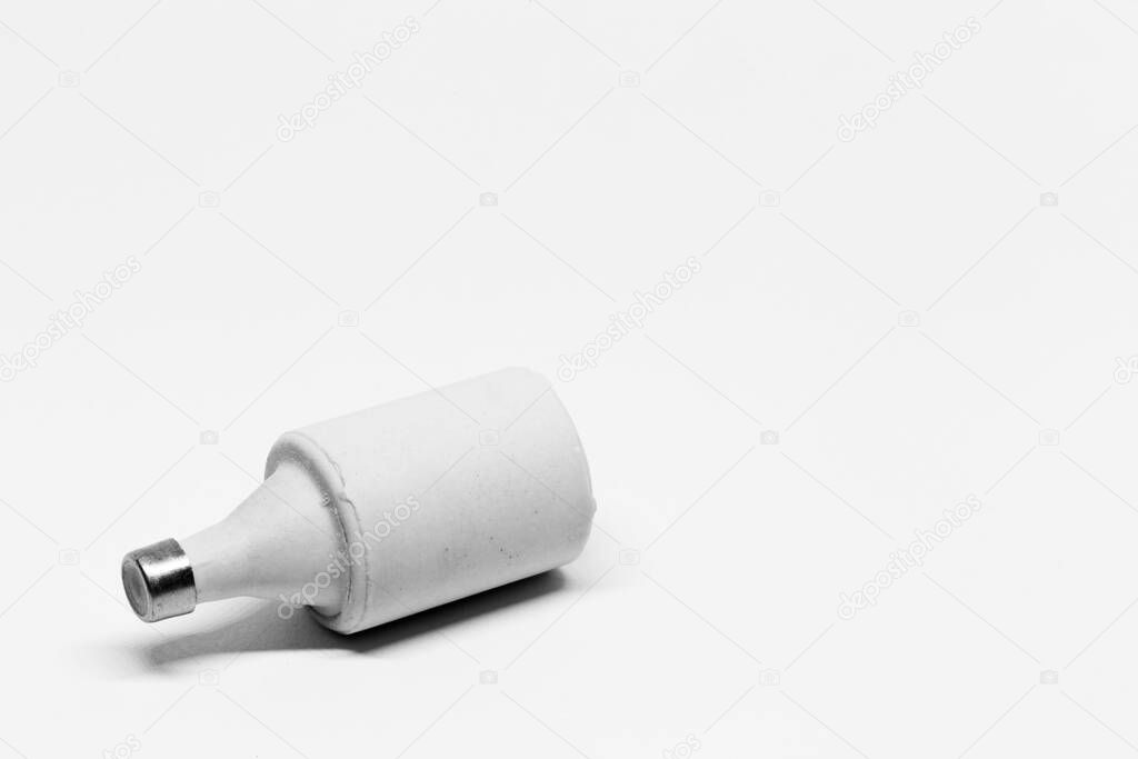 a ceramic electrical fuse on white background