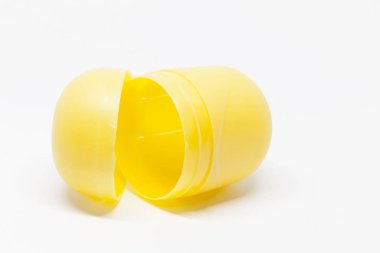 a yellow open toy egg on white background clipart