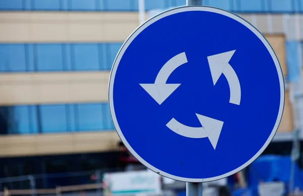 traffic sign circulation site, white arrows on blue background
