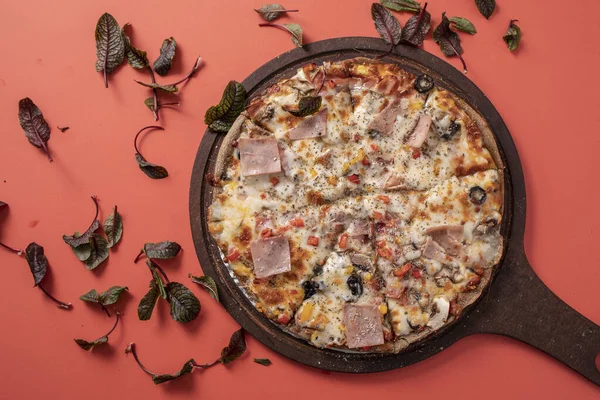 Turkey bacon pizza in red background